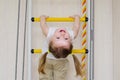 Little girl hangs on the stairs upside down Royalty Free Stock Photo