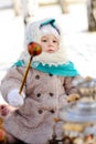 Little girl in a fur coat and a headscarf in the Russian style w Royalty Free Stock Photo