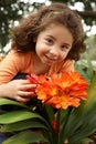 Little girl in a garden of clivia miniata