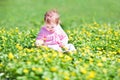 Little girl in garden with many yellow flowers Royalty Free Stock Photo