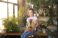 Little girl gardener plants hyacinth. Girl holding hyacinth in flower pot. Child taking care of plants. Royalty Free Stock Photo