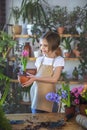 Little girl gardener plants hyacinth. Girl holding hyacinth in flower pot. Child taking care of plants. Royalty Free Stock Photo