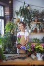 Little girl gardener plants hyacinth. Girl holding hyacinth in flower pot. Child taking care of plants. Royalty Free Stock Photo