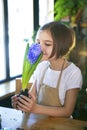 Little girl gardener plants hyacinth. Girl holding hyacinth in flower pot. Child taking care of plants. Royalty Free Stock Photo