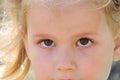 Little girl gazes brown eyes