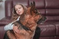 Little girl gently hugs her friendly big dog. Royalty Free Stock Photo