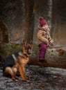 Little girl with German shepherd 6-th months puppy at early spring Royalty Free Stock Photo