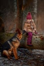 Little girl with German shepherd 6-th months puppy at early spring Royalty Free Stock Photo