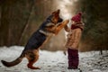 Little girl with German shepherd 6-th months puppy at early spring