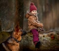 Little girl with German shepherd 6-th months puppy at early spring Royalty Free Stock Photo