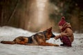 Little girl with German shepherd 6-th months puppy at early spring Royalty Free Stock Photo