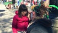 Little girl gets her face painted at New Orleans Carnival