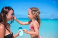 Little girl gets sun cream on her mother's nose Royalty Free Stock Photo