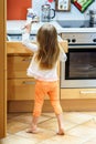 Little girl getting tableware before dinner