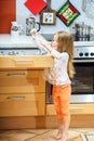 Little girl getting tableware before dinner