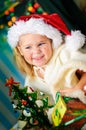 Little girl with gift and Christmas tree