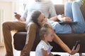 Little girl giggles while watching cartoons with parents