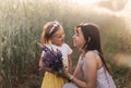 A little girl gives a bouquet of lupines to her mother on the field in the summer. Concept of love and happy family Royalty Free Stock Photo
