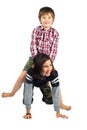 Little Girl Gives Her Younger Brother a Horseback Ride on White Royalty Free Stock Photo