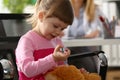 Little girl gives injection to toy closeup