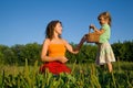 Little Girl gives Young Women basket on glade