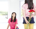 Little girl giving carnation flowers to mother Royalty Free Stock Photo