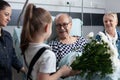 Little girl giving flowers to bedridden elderly man