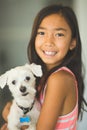 Little girl giving her dog a big hug.