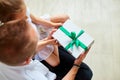 Little girl is giving her handsome father a gift box on Father& x27;s day Royalty Free Stock Photo