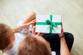 Little girl is giving her handsome father a gift box on Father`s day Royalty Free Stock Photo