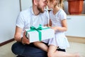 Little girl is giving her handsome father a gift box on Father`s day Royalty Free Stock Photo