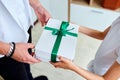 Little girl is giving her handsome father a gift box on Father& x27;s day Royalty Free Stock Photo