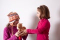 Little girl giving her teddy bear toy to older sister. Cute child girl giving a gift to her sister. Child girl sharing a toy with Royalty Free Stock Photo