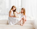 Little girl giving her teddy bear toy to older sister Royalty Free Stock Photo