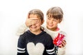 Little girl giving surprise love gift to her friend with white b Royalty Free Stock Photo