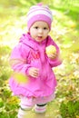 The little girl on a glade with an apple Royalty Free Stock Photo