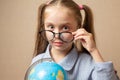 Little girl in glasses holding globe Royalty Free Stock Photo