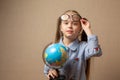 Little girl in glasses holding globe Royalty Free Stock Photo