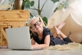 Little girl in glasses with laptop on the floor in her room Royalty Free Stock Photo