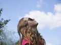 Little girl with glasses looks at the sky Royalty Free Stock Photo