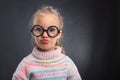 Little girl in glasses makes faces