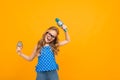 A little girl with glasses with a microphone is interviewed, the picture is isolated on yellow background