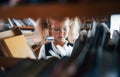 Little girl in glasses searching for a book in the library. Conception of education Royalty Free Stock Photo