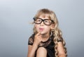 Little girl in glasses thinking