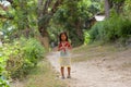 Little girl goes on road in the Philippine village