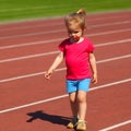 A little girl goes in for track and field athletics at the stadium