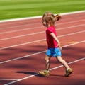 A little girl goes in for track and field athletics at the stadium