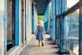 Little girl going on porch of old ruined house. Royalty Free Stock Photo