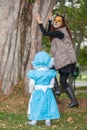 Little girl on grandma costume playing with her mom. Real family having fun while using costumes of the Little red riding hood Royalty Free Stock Photo