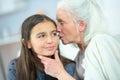 Little girl and grandma whispering secrets